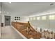 Upstairs hallway with wooden bannister overlooking the bright living space below at 2024 E Taurus Pl, Chandler, AZ 85249