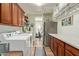 Well-equipped laundry room with modern washer, dryer, cabinets, and stainless steel refrigerator at 2024 E Taurus Pl, Chandler, AZ 85249