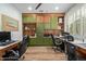 Large home office with built in cabinets and shelves, laminate floors, and office chairs at 2024 E Taurus Pl, Chandler, AZ 85249
