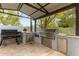 Outdoor kitchen equipped with grill, stainless steel appliances, and ample counter space at 2024 E Taurus Pl, Chandler, AZ 85249