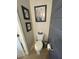 Cozy bathroom with framed artwork and a sleek gray trashcan at 22074 S 211Th St, Queen Creek, AZ 85142