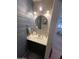 Stylish bathroom vanity with a round mirror and modern fixtures at 22074 S 211Th St, Queen Creek, AZ 85142