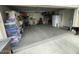 Well-lit garage with organized storage, refrigerator, and room for a vehicle at 22074 S 211Th St, Queen Creek, AZ 85142