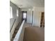 Bright hallway features carpet flooring, an open layout, and access to multiple rooms for seamless navigation at 22074 S 211Th St, Queen Creek, AZ 85142