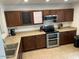 Traditional kitchen features wood cabinets and stainless steel appliances at 22074 S 211Th St, Queen Creek, AZ 85142