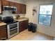 Galley kitchen with stainless steel appliances, a window and tile floors at 22074 S 211Th St, Queen Creek, AZ 85142
