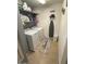 Efficient laundry room with modern washer and dryer, shelving, and ample storage space for convenience at 22074 S 211Th St, Queen Creek, AZ 85142