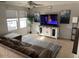 Inviting living room with a ceiling fan, large windows, and a comfortable couch at 22074 S 211Th St, Queen Creek, AZ 85142
