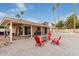 Inviting backyard features low maintenance landscaping and red Adirondack chairs around a fire pit at 2324 E Cortez St, Phoenix, AZ 85028