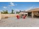 Low maintenance backyard features an extended patio, gravel, and comfortable outdoor swing at 2324 E Cortez St, Phoenix, AZ 85028