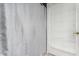 Bright bathroom features a decorative shower curtain and a door with horizontal window blinds at 2324 E Cortez St, Phoenix, AZ 85028