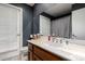Dark bathroom featuring a single sink vanity, marble counter, and window at 2324 E Cortez St, Phoenix, AZ 85028