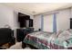 Cozy bedroom with dark furniture, TV, and blue patterned curtains at 2324 E Cortez St, Phoenix, AZ 85028