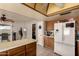 Functional kitchen with a large refrigerator, a kitchen island, and a doorway to the laundry area at 2324 E Cortez St, Phoenix, AZ 85028
