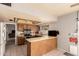 Open kitchen featuring stainless steel appliances, a breakfast bar, and easy access to outdoor entertaining spaces at 2324 E Cortez St, Phoenix, AZ 85028
