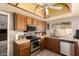 Well-equipped kitchen featuring stainless steel appliances, wooden cabinetry, and natural light from the window at 2324 E Cortez St, Phoenix, AZ 85028
