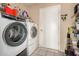 Convenient laundry room offers a full-size washer and dryer and storage shelves at 2324 E Cortez St, Phoenix, AZ 85028