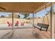 Cozy covered patio featuring an outdoor swing and lounge area, perfect for relaxation and enjoying fresh air at 2324 E Cortez St, Phoenix, AZ 85028