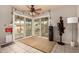 Cozy sunroom with tile flooring, a ceiling fan, and sliding glass doors leading to an outdoor patio area at 2324 E Cortez St, Phoenix, AZ 85028