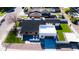 An aerial shot showcases a modern home with a dark roof, white exterior, pristine landscaping, and a spacious backyard at 2546 E Roma Ave, Phoenix, AZ 85016