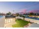 An expansive backyard boasting lush artificial turf, a modern design, and privacy fencing at 2546 E Roma Ave, Phoenix, AZ 85016