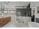 Modern bathroom boasts a glass-enclosed shower, a soaking tub, and stylish vanity with wood accents at 2546 E Roma Ave, Phoenix, AZ 85016