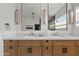 Bright bathroom featuring double vanity, marble countertop, and modern light fixtures at 2546 E Roma Ave, Phoenix, AZ 85016
