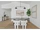 Modern dining room with stylish light fixture, neutral decor, and textured rug at 2546 E Roma Ave, Phoenix, AZ 85016