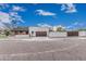 Contemporary home with modern garage, brick accents, and a well-maintained landscape, showcasing clean lines and street appeal at 2546 E Roma Ave, Phoenix, AZ 85016
