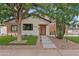 Charming home exterior featuring a brick accent, modern lighting, manicured landscaping, and a welcoming entrance at 2546 E Roma Ave, Phoenix, AZ 85016