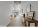 Hallway with a long view to the living room featuring stylish decor and natural light at 2546 E Roma Ave, Phoenix, AZ 85016