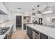 Spacious modern kitchen featuring gray cabinetry and a view of the living room at 2546 E Roma Ave, Phoenix, AZ 85016