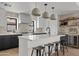Modern kitchen with island, sleek countertops, pendant lighting, and stainless steel appliances at 2546 E Roma Ave, Phoenix, AZ 85016