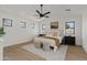 Inviting main bedroom featuring a plush bed, modern fan, and warm natural light at 2546 E Roma Ave, Phoenix, AZ 85016