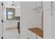 Organized mudroom features hooks, bench, and white cabinetry for efficient storage at 2546 E Roma Ave, Phoenix, AZ 85016