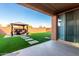View of artificial grass in backyard, with a patio set beneath a gazebo-like structure at 25627 N 163Rd Dr, Surprise, AZ 85387