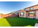 A well maintained backyard with artificial grass and block wall fencing at 25627 N 163Rd Dr, Surprise, AZ 85387