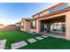 Wide angle view of a backyard featuring synthetic grass and access to the home's covered patio at 25627 N 163Rd Dr, Surprise, AZ 85387