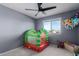 This playful bedroom features a whimsical play area, window, and ample space for fun and games at 25627 N 163Rd Dr, Surprise, AZ 85387