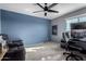 This bedroom has carpeting, a ceiling fan, and provides a comfortable space for relaxation or a productive work area at 25627 N 163Rd Dr, Surprise, AZ 85387