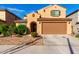 Inviting home featuring desert landscaping, covered entry, and an attached two-car garage at 25627 N 163Rd Dr, Surprise, AZ 85387