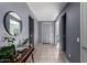 Hallway featuring tile flooring, a round mirror, and gray walls at 25627 N 163Rd Dr, Surprise, AZ 85387