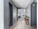 Hallway featuring tile flooring, gray walls, white doors, and a view to the living room at 25627 N 163Rd Dr, Surprise, AZ 85387