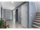Hallway featuring tile flooring, gray walls, white doors, and a stairway at 25627 N 163Rd Dr, Surprise, AZ 85387