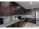 Modern kitchen featuring granite countertops and stainless steel appliances at 25627 N 163Rd Dr, Surprise, AZ 85387