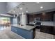 Bright eat-in kitchen with granite countertops, tile floors, and pendant lighting above the island at 25627 N 163Rd Dr, Surprise, AZ 85387