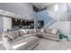 Open living room features high ceilings, large sectional sofa, and view into the kitchen at 25627 N 163Rd Dr, Surprise, AZ 85387