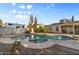 Inviting backyard featuring a sparkling pool, diving board, and cozy patio area, perfect for relaxing at 2616 E Des Moines St, Mesa, AZ 85213