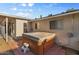 Cozy backyard featuring a hot tub, brick patio, and a glimpse of the home's exterior at 2616 E Des Moines St, Mesa, AZ 85213