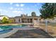 Private backyard oasis with a sparkling pool, lounge chairs, and secure fencing at 2616 E Des Moines St, Mesa, AZ 85213